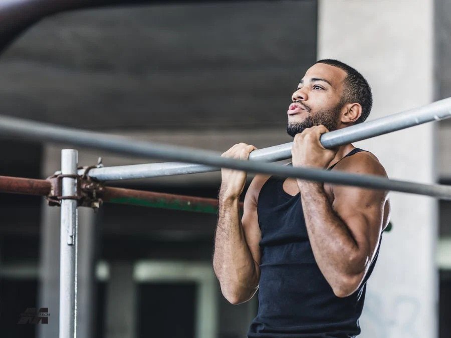 Man performing chin ups for training arms