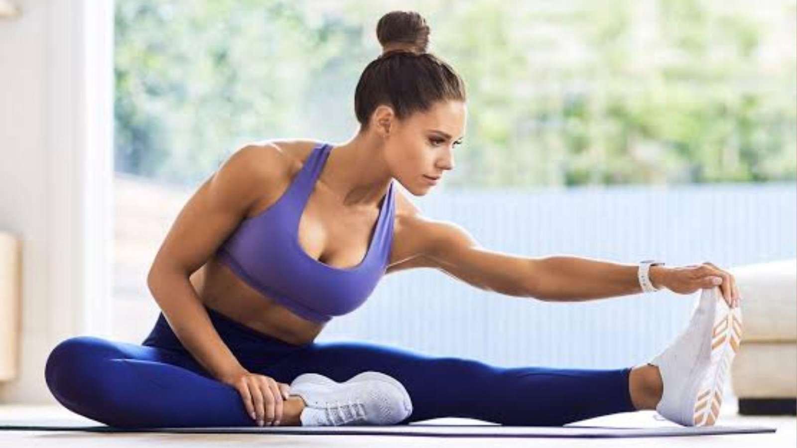 Woman stretching in athleisure.