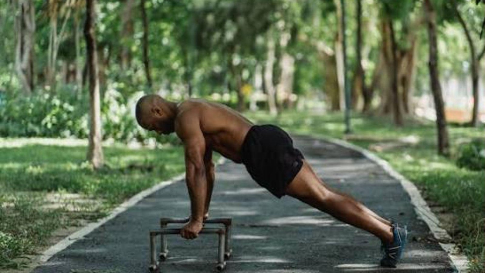 man working out in an outdoors setting.