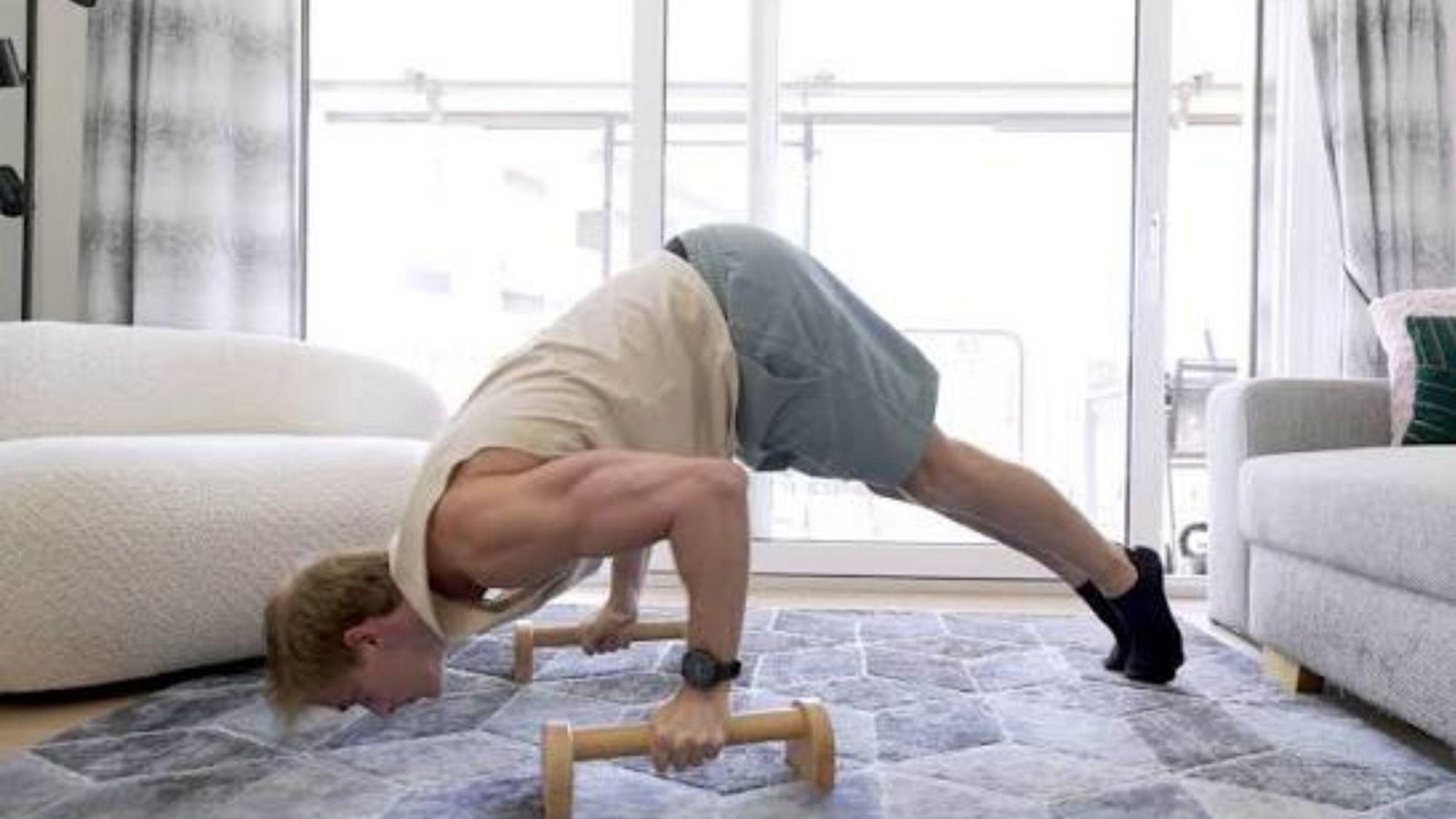 Man doing handstand pushups.