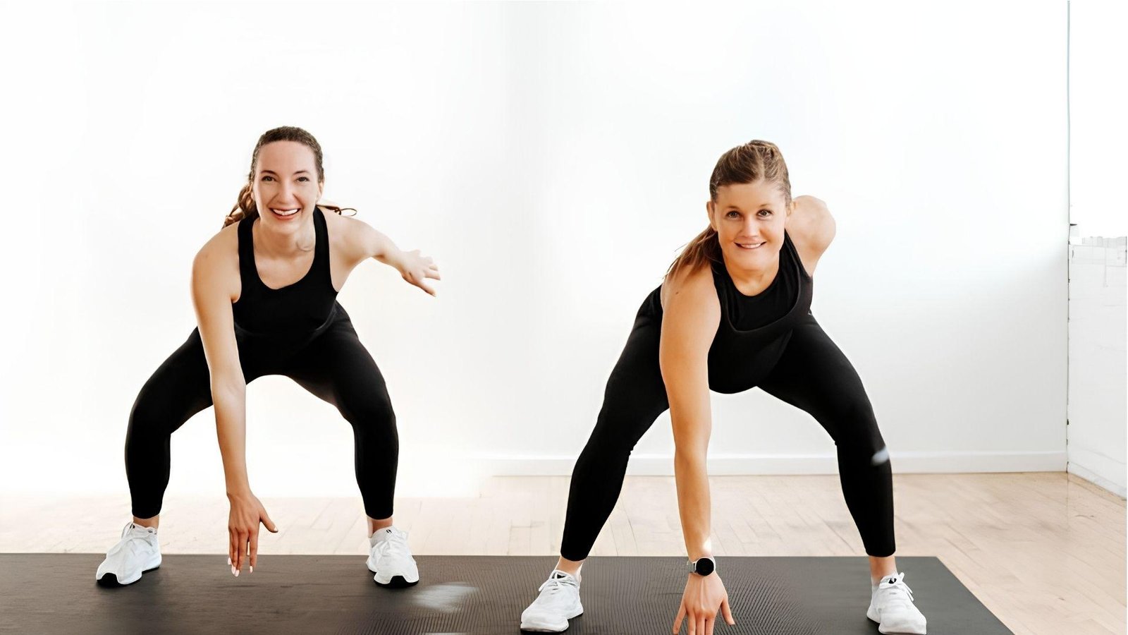 Two women doing wide-leg squats on mat, beginner first trimester workout