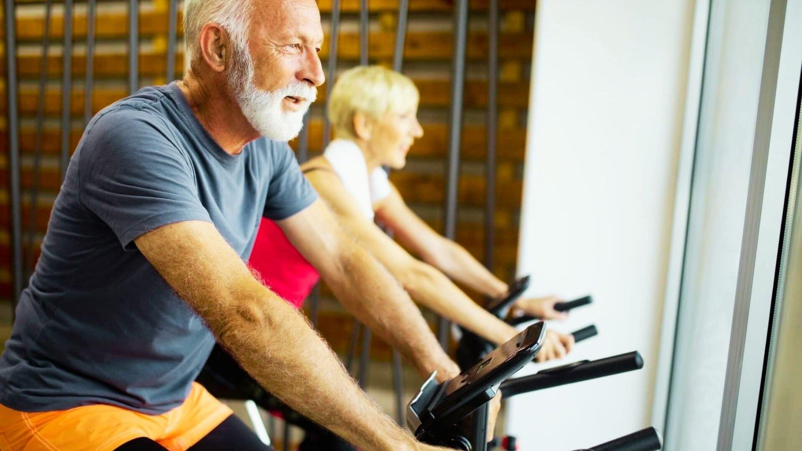 Senior exercising safely on a stationary bike.