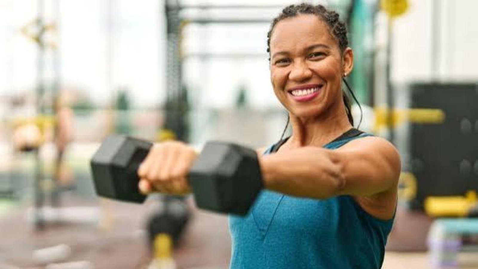 woman smiling while working out.