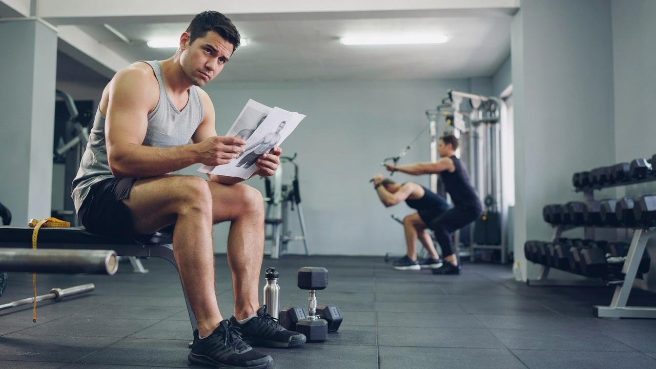 Person frustrated by lack of workout progress.