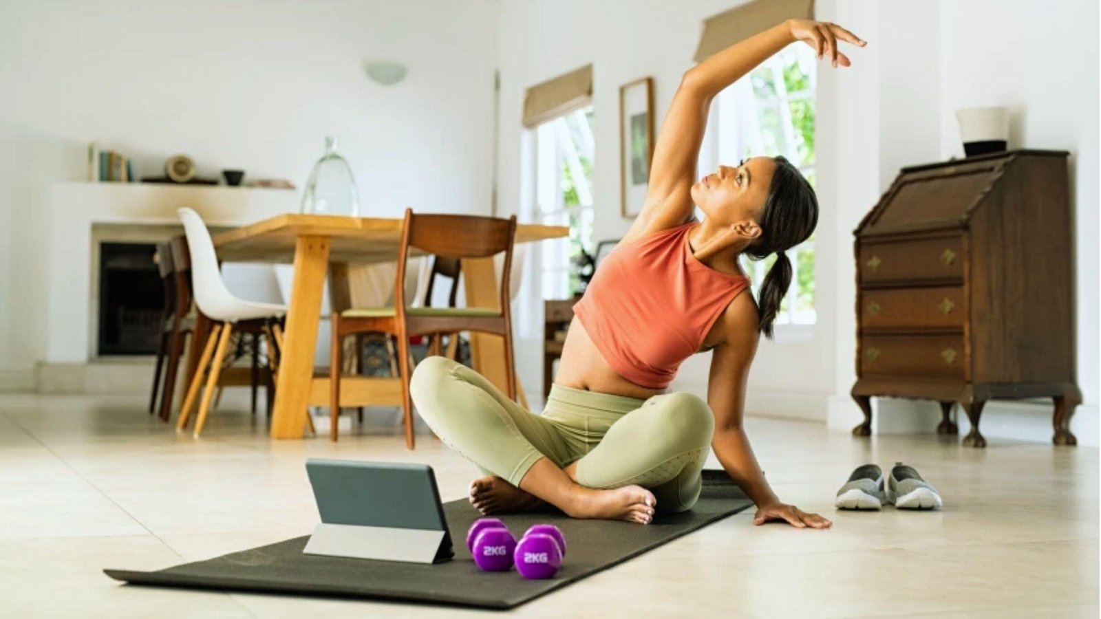 a girl doing exercise using an app on the ipad.