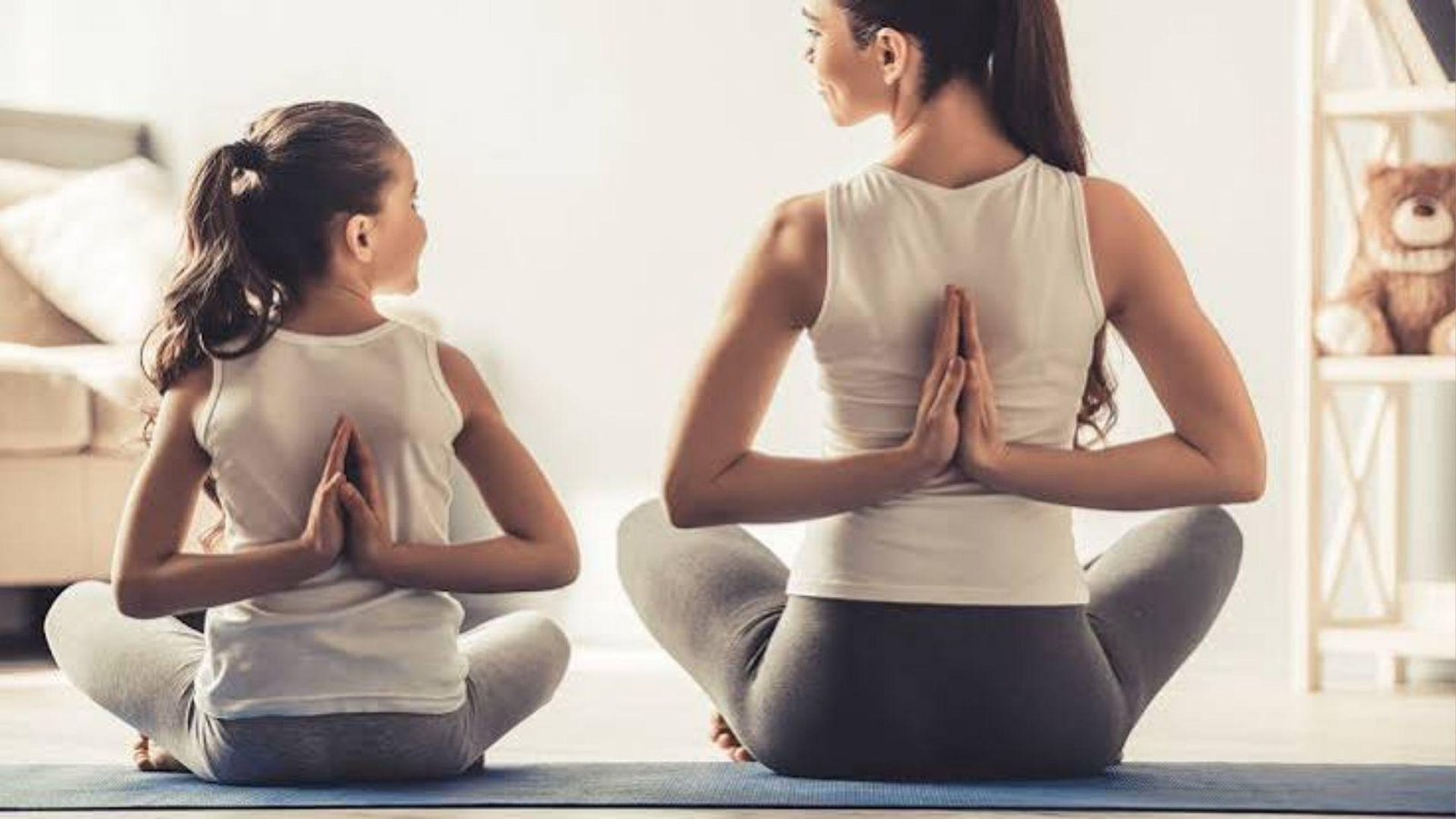 woman and child doing yoga.