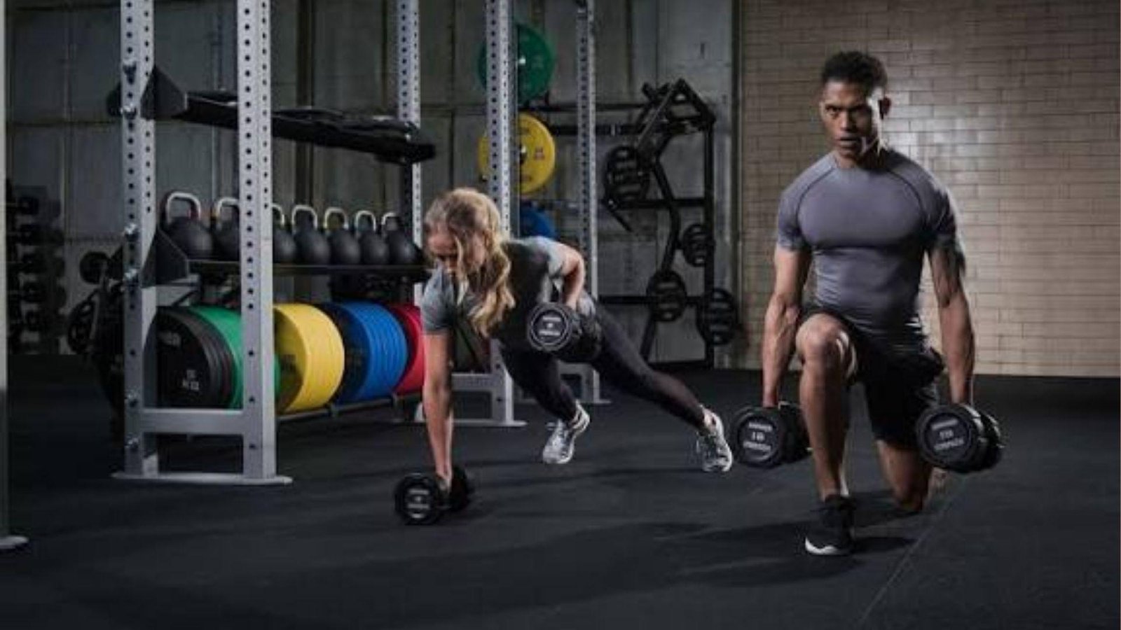 man and woman working out in gym.