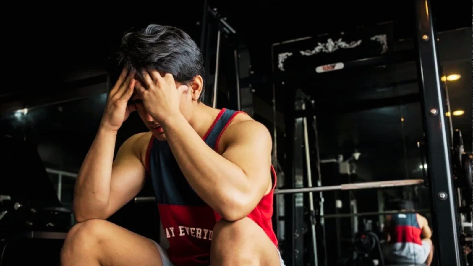 Person looking exhausted after a gym workout, representing signs a workout is not working.